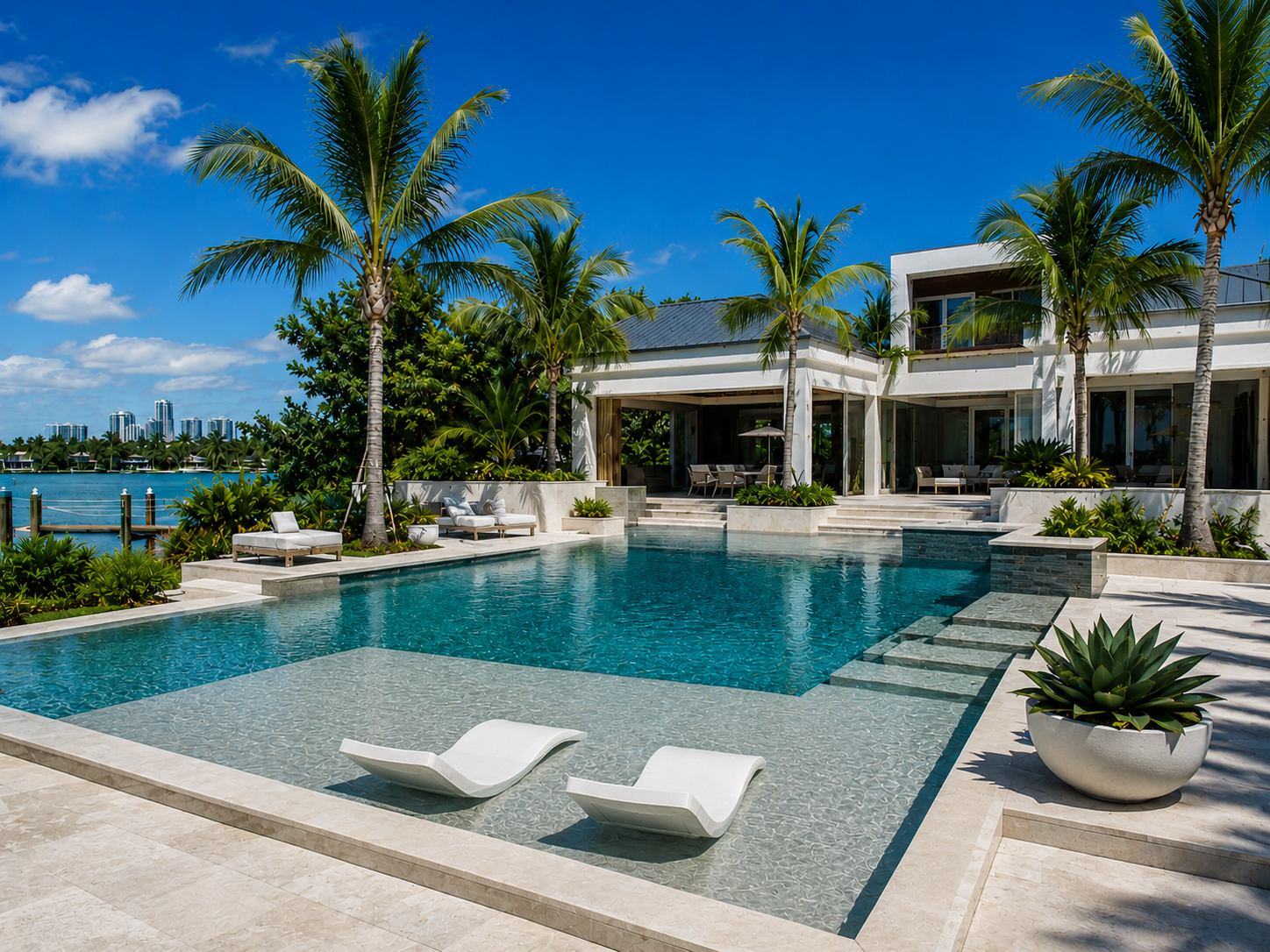 Luxury pool with palm trees and waterway views